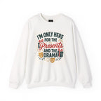 White holiday sweatshirt with "I'm Only Here for the Presents and the Drama" festive print and gift and theater mask illustrations