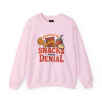 Crewneck Sweatshirt — "Powered by Snacks and Denial" Funny Snack Lover Pullover