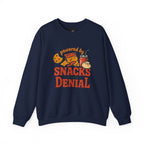 Crewneck Sweatshirt — "Powered by Snacks and Denial" Funny Snack Lover Pullover