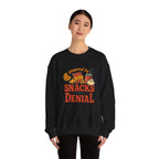 Crewneck Sweatshirt — "Powered by Snacks and Denial" Funny Snack Lover Pullover