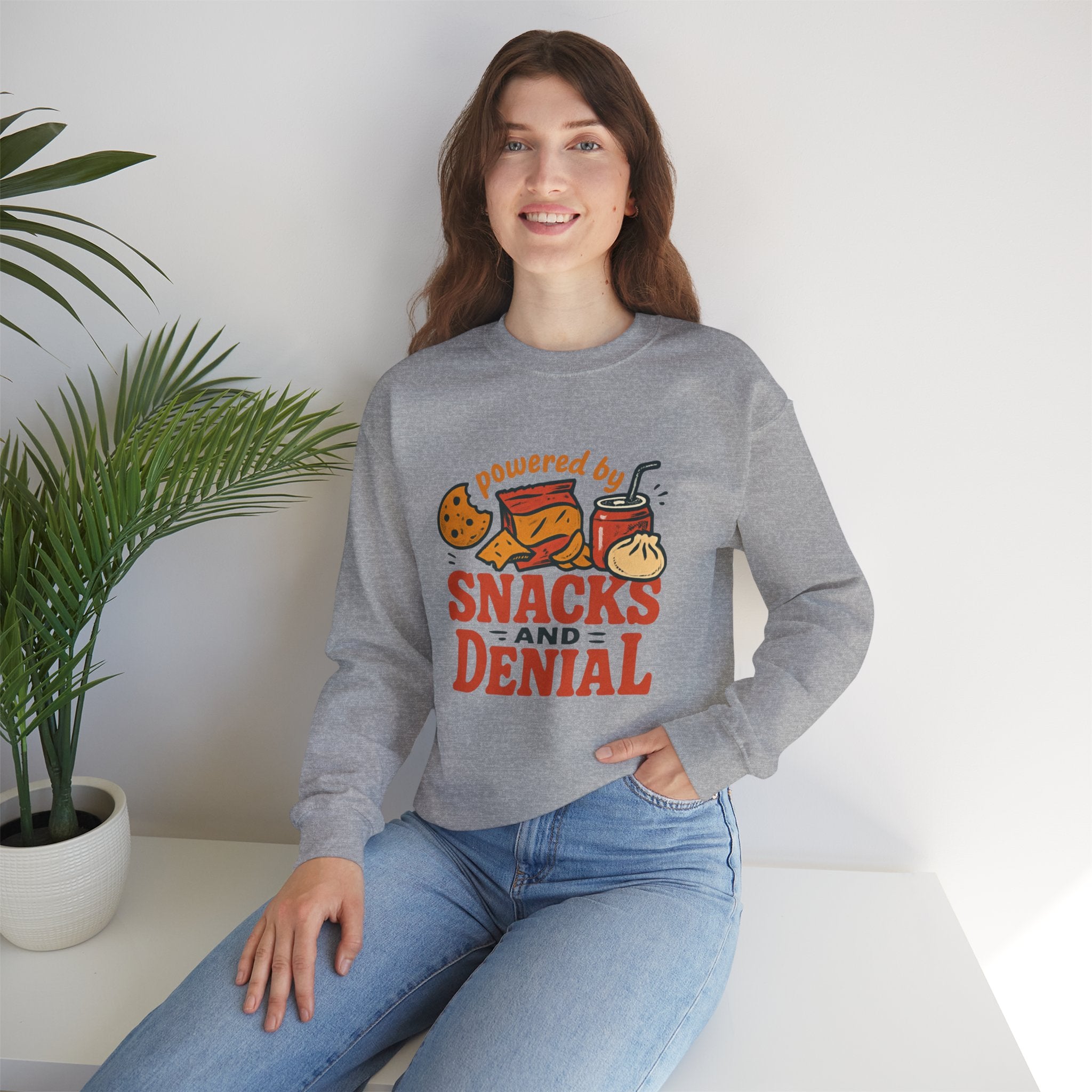 Crewneck Sweatshirt — "Powered by Snacks and Denial" Funny Snack Lover Pullover